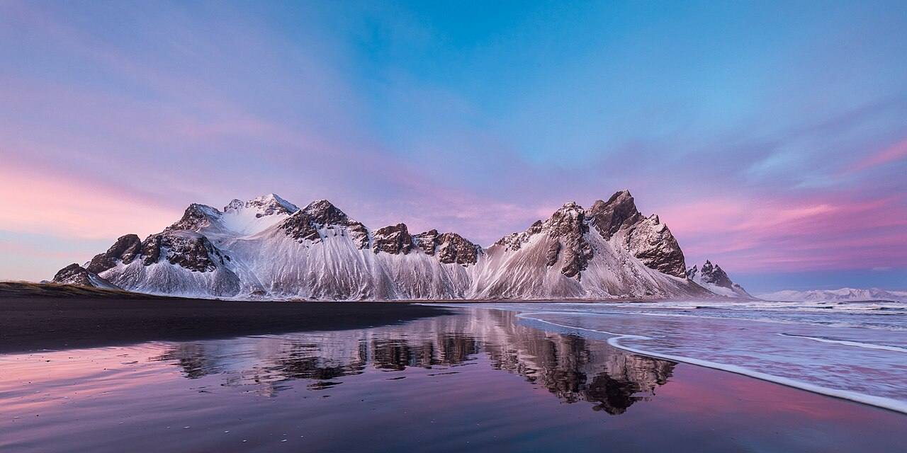 Winter light on Vestrahorn from Stokksnes; reflections are conditional.
